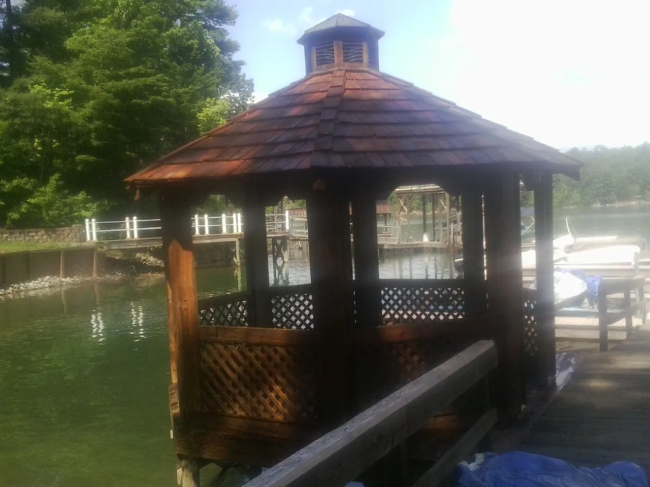 Cedar shake gazebo roof rebuilt on a lake dock in Bristol